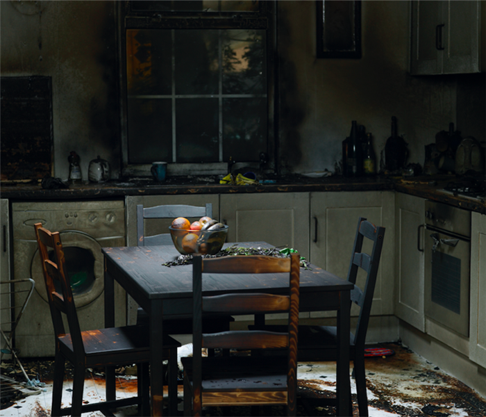 Burnt kitchen table and chairs. With fruit bowl in middle.