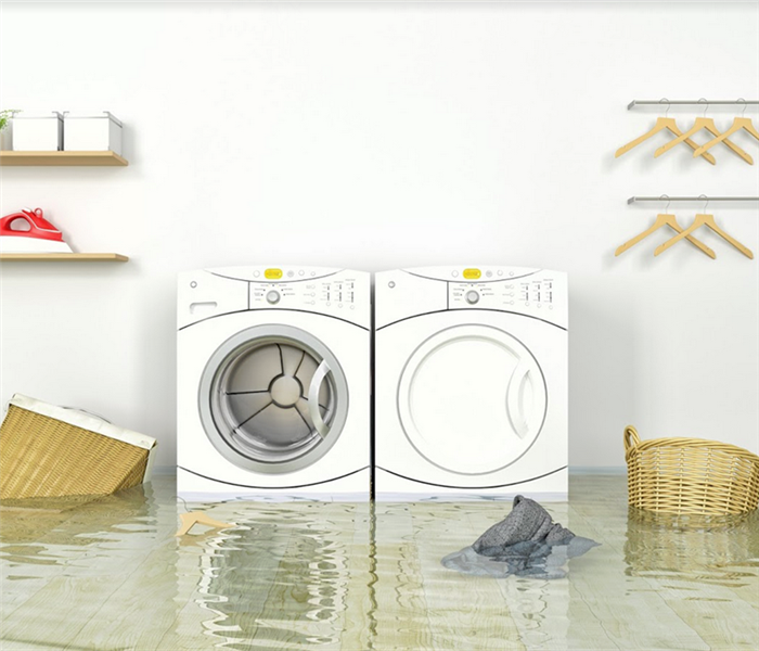 flooded laundry room with washer and dryer