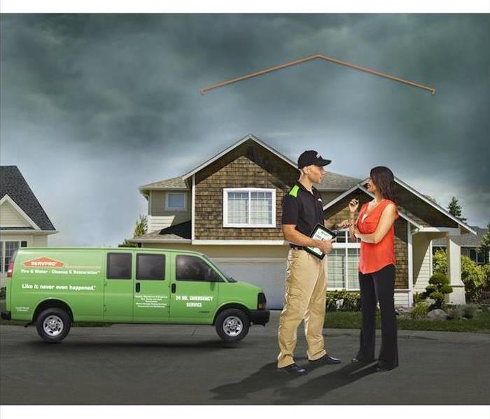 SERVPRO technician consulting with customer