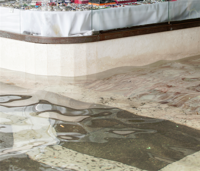 the outside of a store with water up to its windows from flooding
